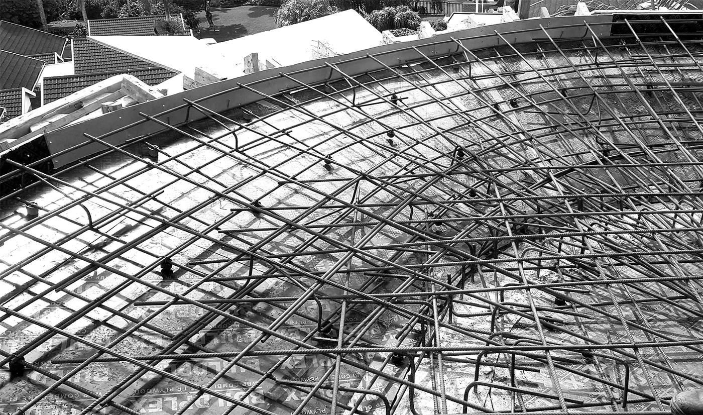 Curved reinforcement arranged over formwork