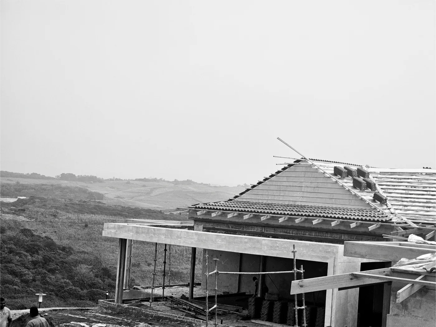 Roof construction progressing over a residential-scale structure