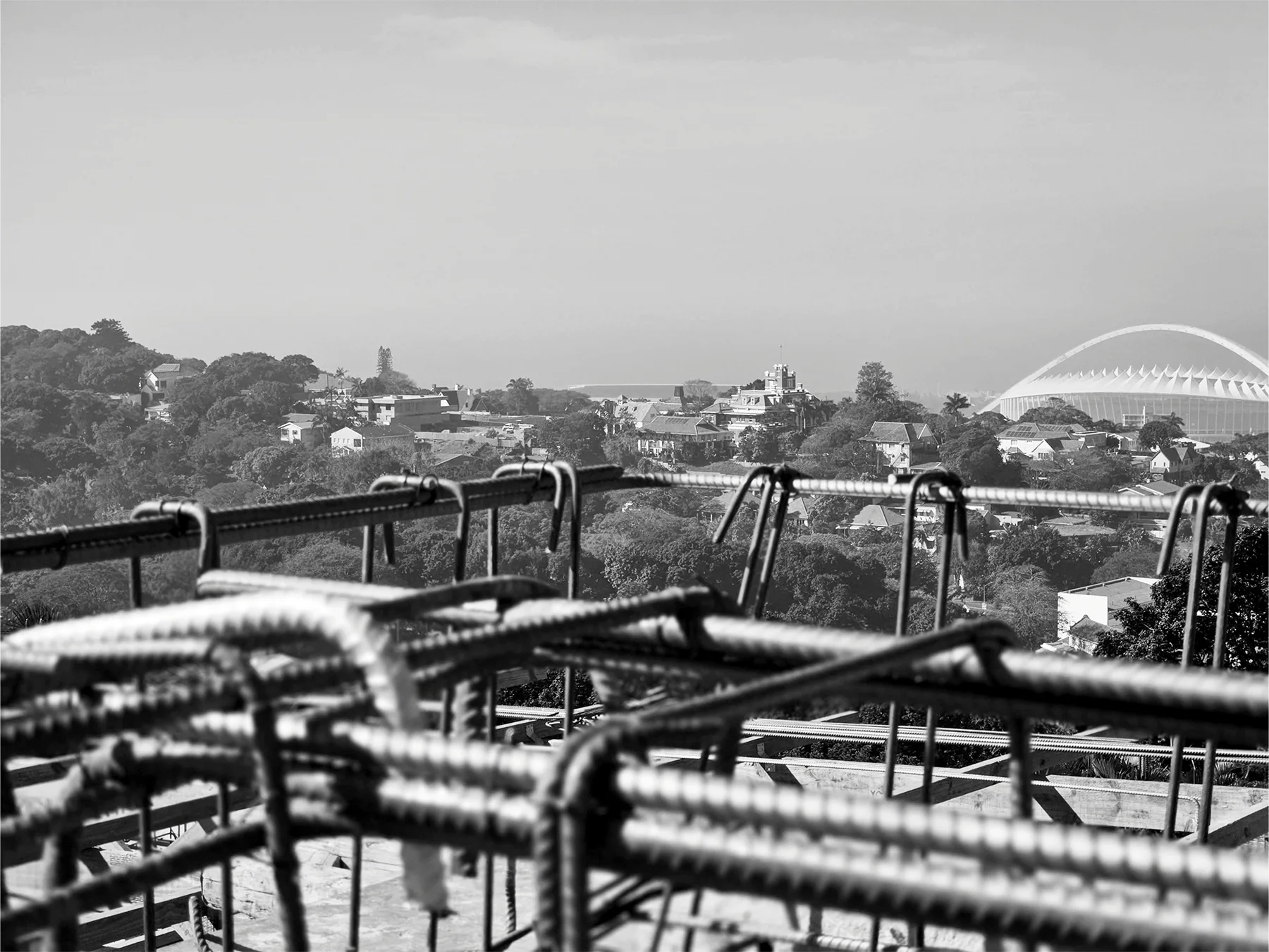 Greyscale view across reinforcement and the surrounding built environment