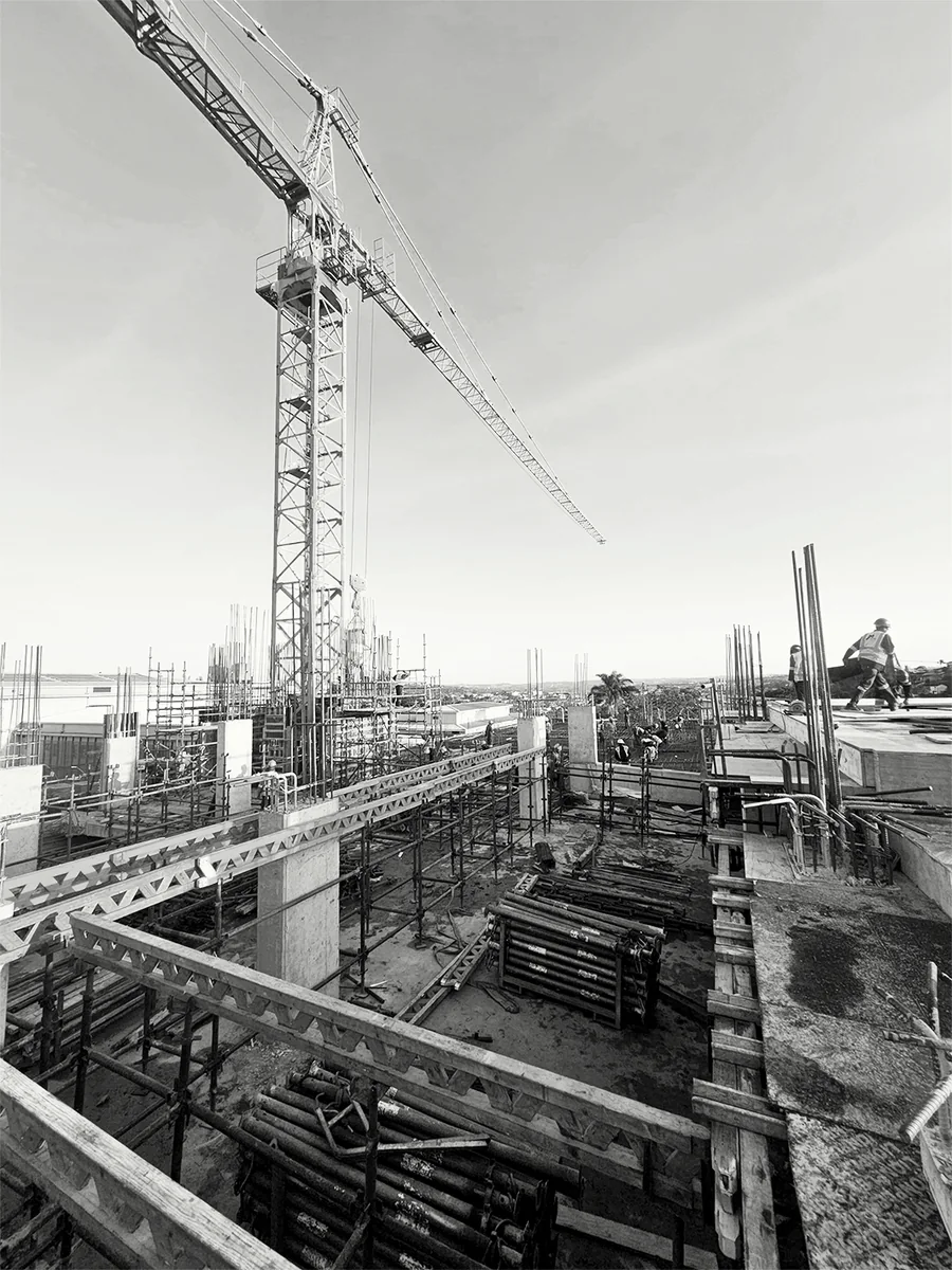 Vertical view across concrete construction and a tower crane